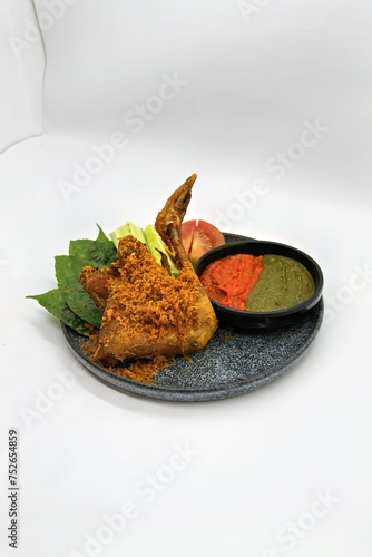 Ayam Goreng Kalasan, Indonesian food from Kalasan, Yogyakarta. It's fried chicken that cooked with special spice, combined with 'kremes', a crispy fried flour. Selective Focus