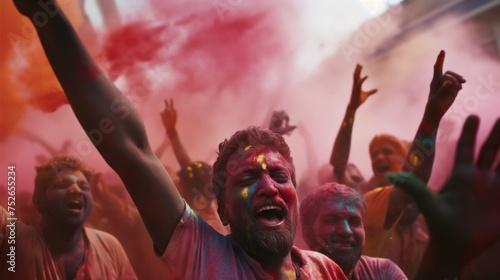 A man with a colored face celebrating the festival of colors Holi. Man having fun with colorful paints, Holi festival.