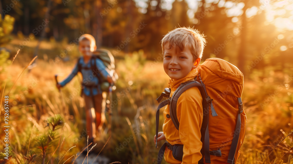 Portrait of a smiling young boy hiking with his brother or friend at the park at spring at sunset Portrait of a smiling young boy hiking with his brother or friend at the park at spring at sunset