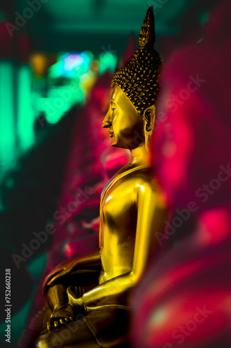 Golden Buddha statue in a temple at Nakhon Sawan Province photo