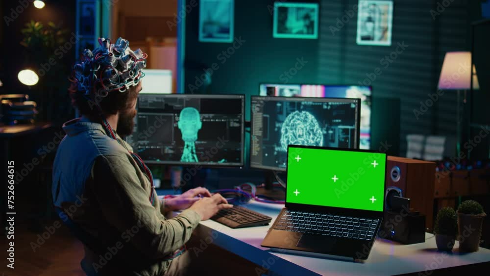 IT admin coding and using EEG headset to upload brain into green screen laptop, gaining immortality. Neuroscientist engineering transhumanism experiment on chroma key device, camera B IT admin coding and using EEG headset to upload brain into green screen laptop, gaining immortality. Neuroscientist engineering transhumanism experiment on chroma key device, camera B