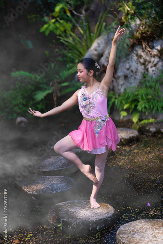 A girl beautiful ballerina dancing outdoors in a park. Ballerina Project