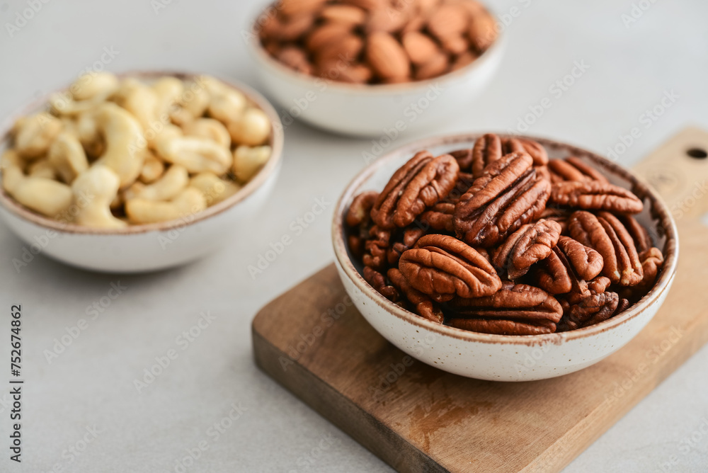 Pecan nuts, almond and cashew in bowls Pecan nuts, almond and cashew in bowls