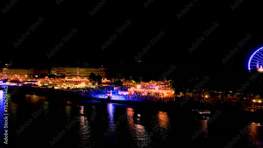 Wine fair at night illuminated with large crowds in Bordeaux France, Aerial dolly in shot Wine fair at night illuminated with large crowds in Bordeaux France, Aerial dolly in shot