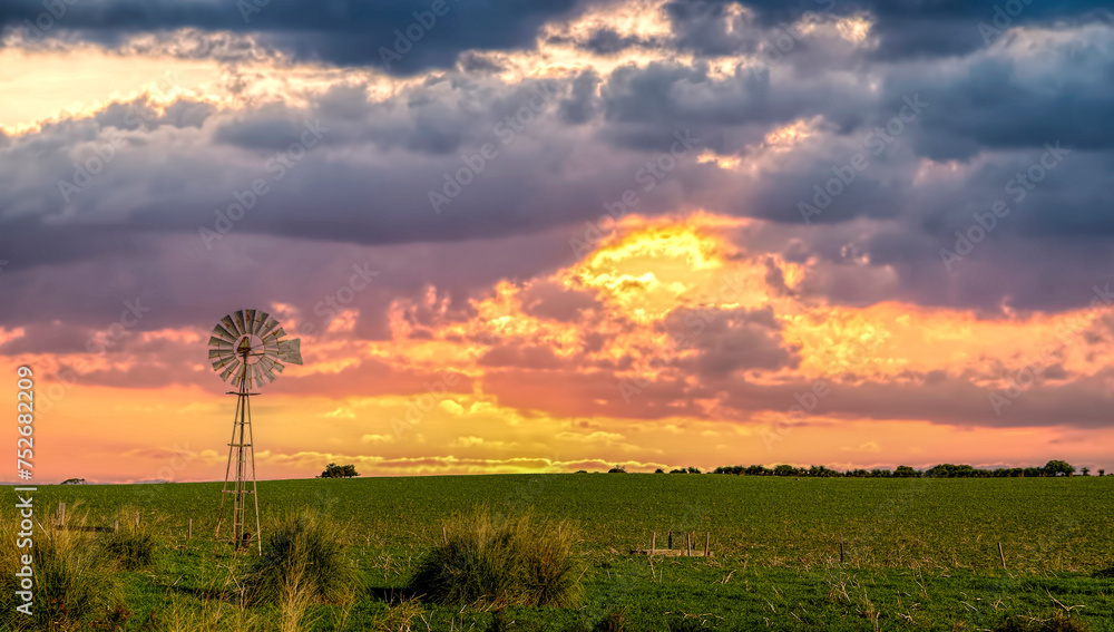 Beautiful old windmill at sunset on Farmland , Western Australia