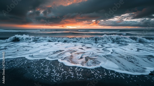 Picturesque view of dark foamy waves of ocean water against cloudy sundown sky in evening in reynisfjara beach, iceland