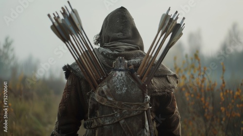 An archer proudly displays his quiver which is filled with a variety of arrows designed for different combat scenarios. photo