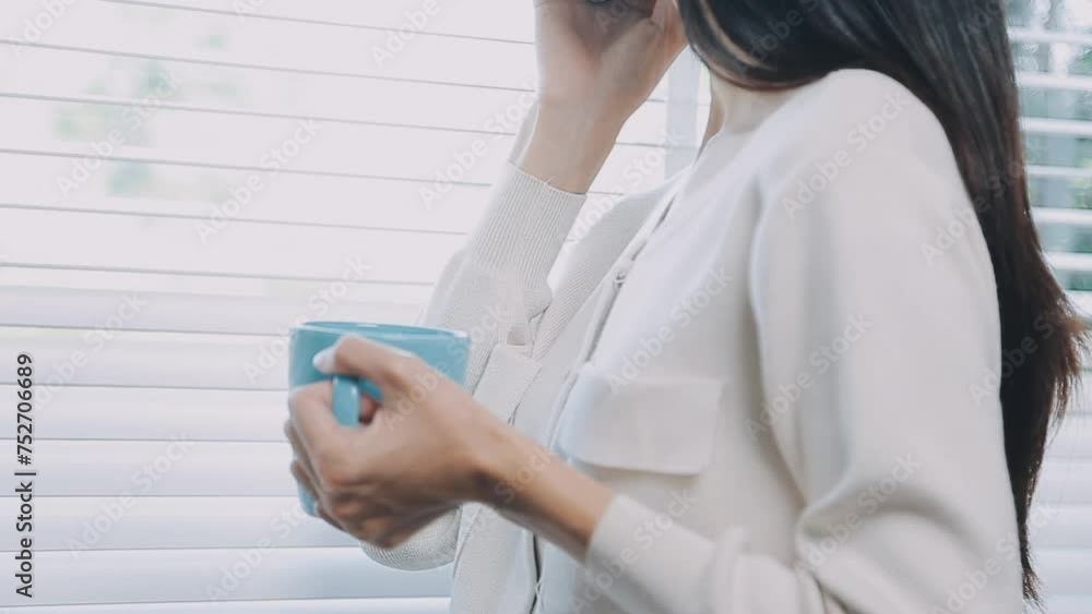 Smiling businesswoman using phone in office. Small business entrepreneur looking at her mobile phone and smiling.. Smiling businesswoman using phone in office. Small business entrepreneur looking at her mobile phone and smiling..