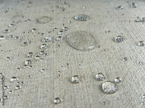 Close-up shot of water droplets on a concrete slab