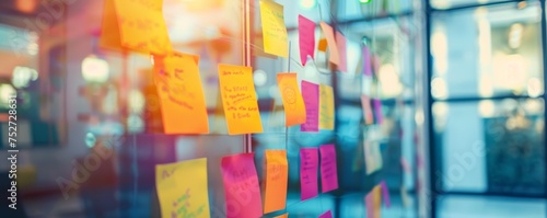 An inspiring setup displaying innovative project development using colorful Post-it notes strategy on a clear glass surface in a bright office space.