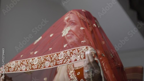 Attractive Smiling Indian Bride In Traditional Red Wedding Veil (Dupatta). closeup shot photo