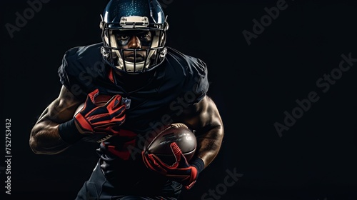 The American football player is isolated against a black background. © shaiq