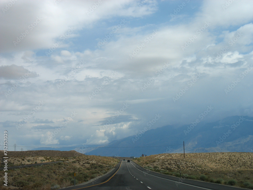 American road. Beautiful Pacific Northwest landscape with blue sky and white clouds. California highway.
