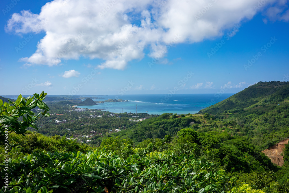 Captivating Panoramic View of Lombok's Coastal Landscape, Indonesia, Framed by Lush Greenery