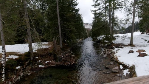 Mountain river among snow-capped peaks. 4K