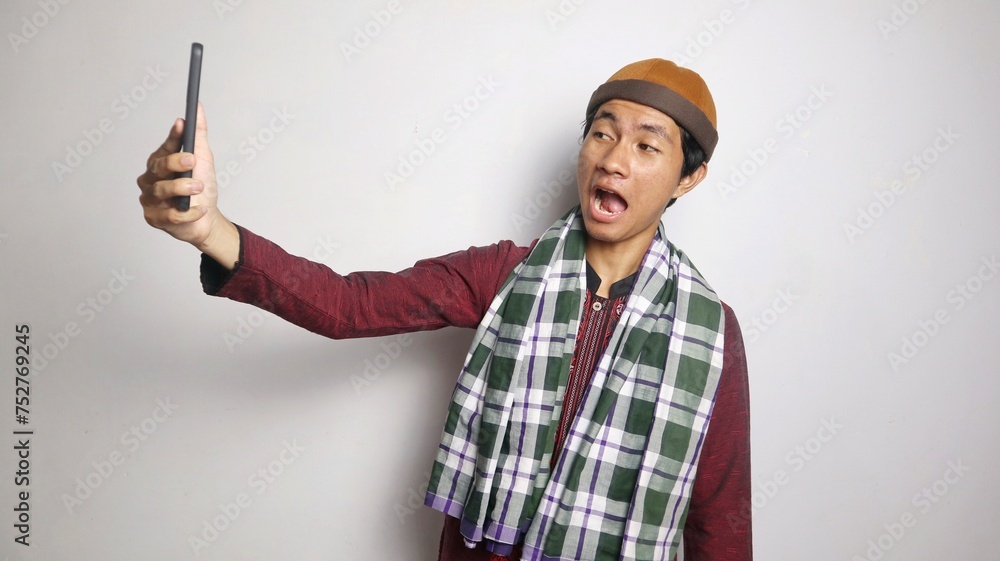 shocked Asian Muslim man selfie, video call on smartphone
