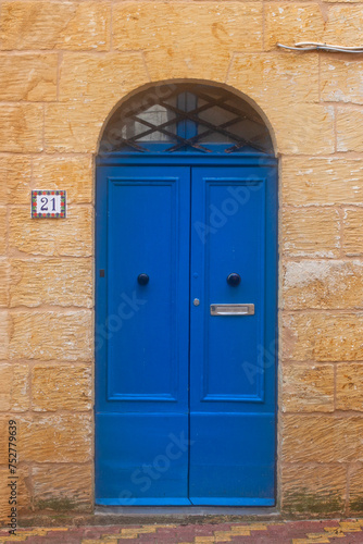 Blue door in house on the street of ancient city Rabat with traditional maltese houses built of limestone, Victoria, Malta © Alexandra Lande