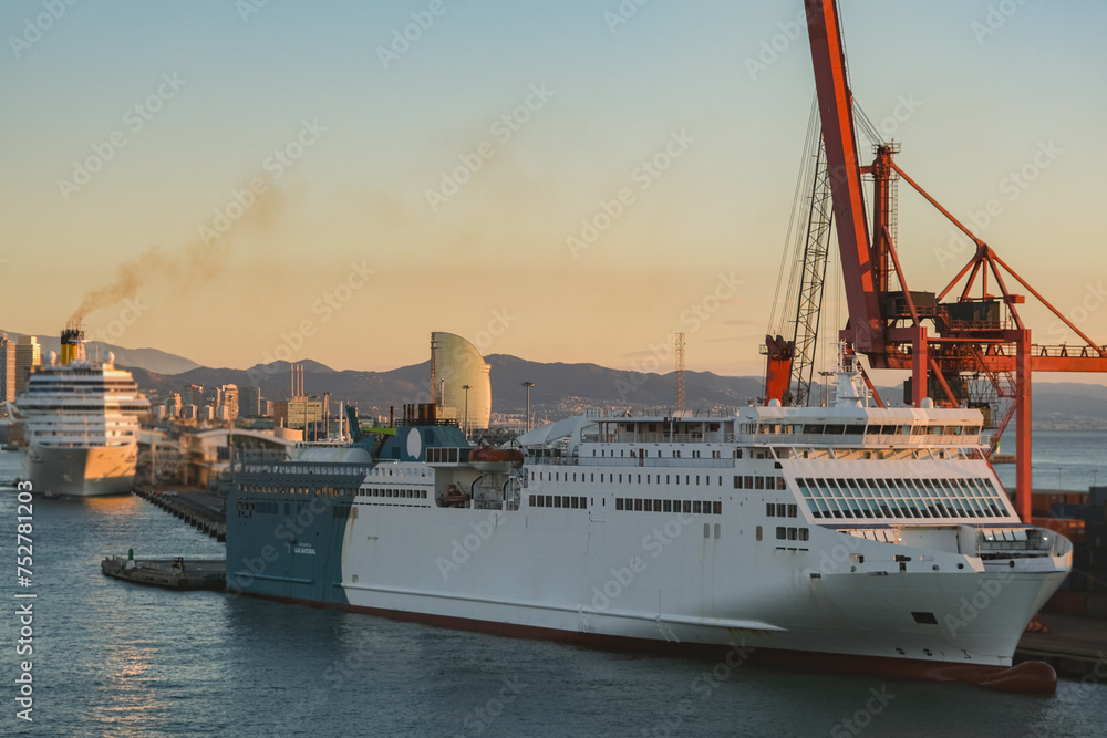 Fototapeta premium Mega LNG powered car, passengers pax and cargo transporter ro-ro ferry ship cruiseship cruise liner in Barcelona port, Spain with harbor and city skyline 