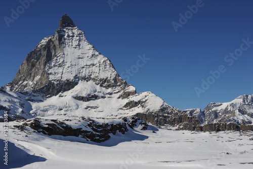 Matterhorn mountain peak in Alps in winter with snow and clear blue sky, Zermatt, Switzerland