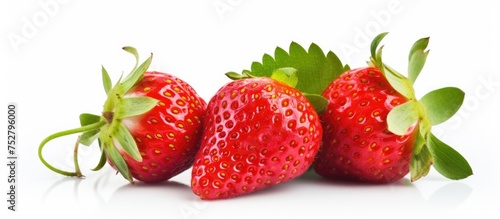 Vibrant Three Strawberries with Lush Green Leaves on Clean White Background