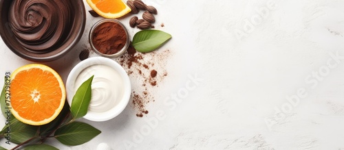 Artistic Composition of Chocolate and Orange Slices with Green Leaves on Clean White Background