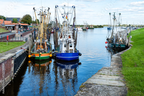 Fish boats in the Small idyllic harbor of Greetsiel-Krummhörn, north sea, Germany photo