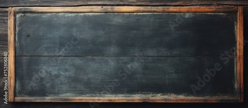 Rustic Blackboard with Wooden Frame Hanging on a Textured Wooden Wall