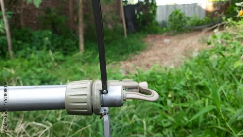 A cameramen is setting camera tripot in outdoor photo