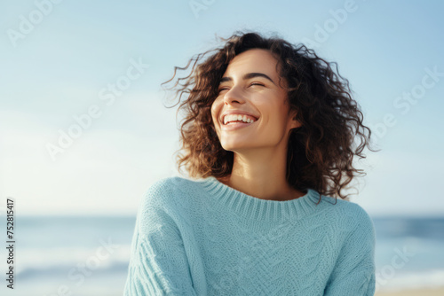 Joyful woman enjoying sunshine on sandy beach. Emotional wellbeing and relaxation. © Postproduction