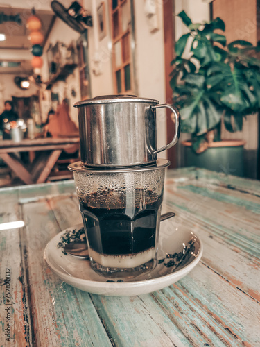 A general view of black Vietnamese coffee with condensed sweetend milk with retro film color filter applied.