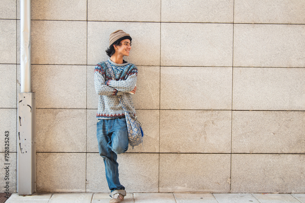 urban young man posing on the wall urban young man posing on the wall