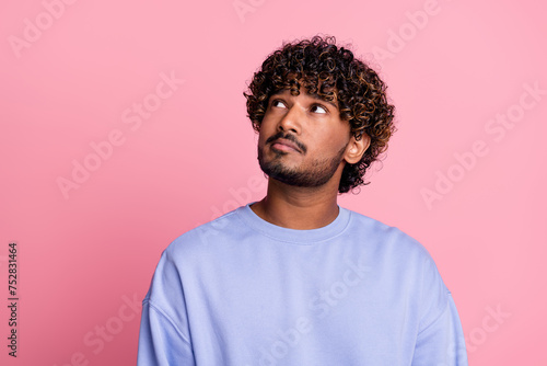 Photo of minded young man dressed trendy blue clothes look up banner news decide dilemma hmm isolated on pink color background