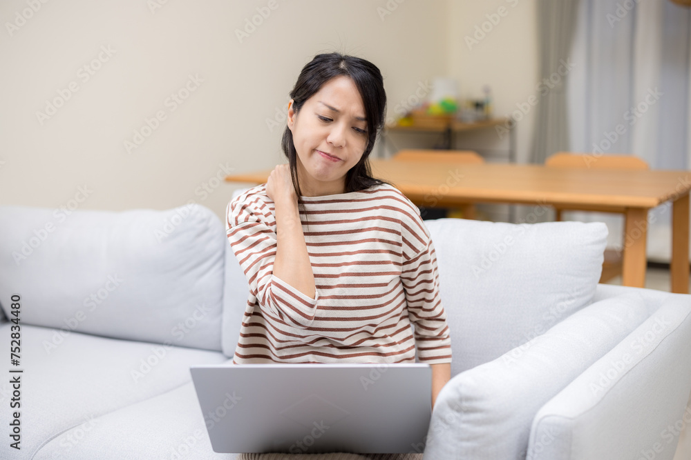 Woman suffer from the neck tensed muscles fatigued after using laptop computer for so long at home Woman suffer from the neck tensed muscles fatigued after using laptop computer for so long at home