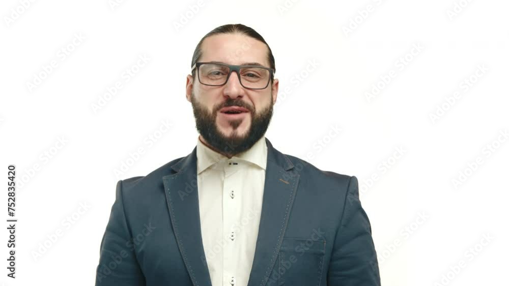 Man in a formal suit nods in agreement while on a call, displaying a positive reaction with a clear blue background enhancing his professional appearance. Camera 8K RAW. Man in a formal suit nods in agreement while on a call, displaying a positive reaction with a clear blue background enhancing his professional appearance. Camera 8K RAW.