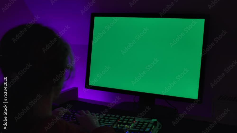 Girl of Green Screen Display PC at Desk in Home at Night. Desktop PC Monitor With Green Mockup, Chroma Key, Working. Person Teenager Programer Typing Codes Mockup Computer. Software Development. Girl of Green Screen Display PC at Desk in Home at Night. Desktop PC Monitor With Green Mockup, Chroma Key, Working. Person Teenager Programer Typing Codes Mockup Computer. Software Development.