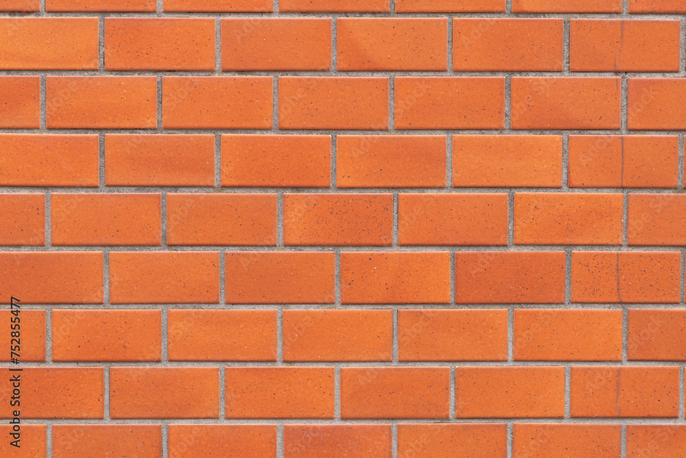 Fototapeta premium オレンジのレンガ調のタイルの壁