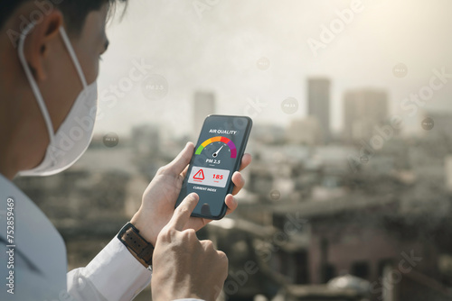 air pollution quality of dust PM 2.5 is toxic and dangerous to health. .People use technology smart phone check air quality smog from PM2.5 dust, warning dangerous unhealthy air pollution dust smoke