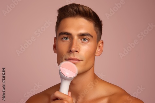 
Close-up shot of a man confidently using a facial cleansing brush, epitomizing soft masculinity through his dedication to a thorough skincare routine photo