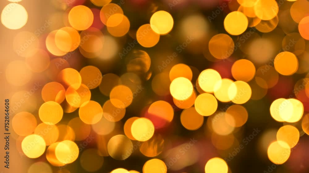 Blurred background of lights on Christmas tree. Bright yellow and golden lights bokeh sparkling on Christmas tree, festive background Blurred background of lights on Christmas tree. Bright yellow and golden lights bokeh sparkling on Christmas tree, festive background