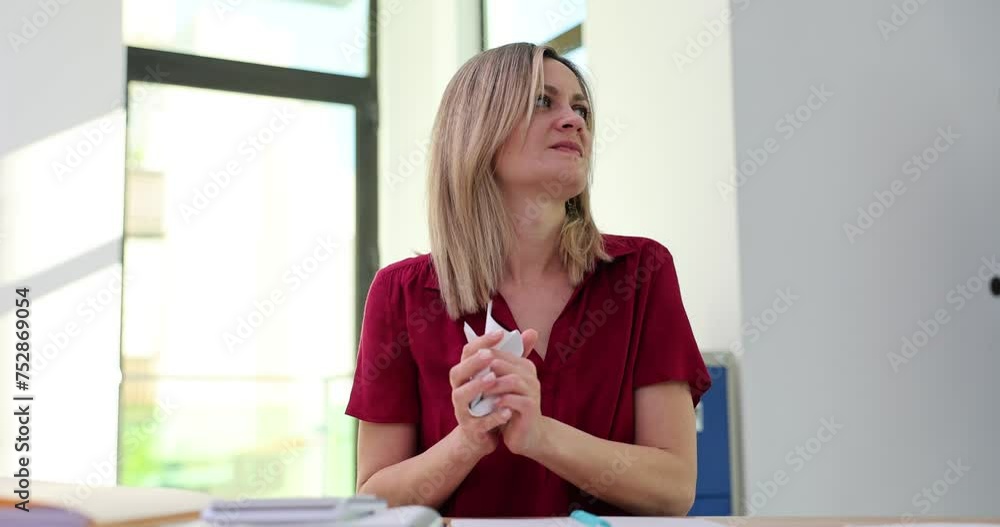 Emotional woman reads bad information and crumbles letter Emotional woman reads bad information and crumbles letter