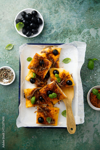 Traditional savory pie with anchovy and olives photo