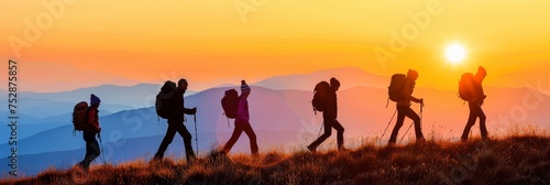 Adventurous group of hikers enjoying a mountain sunset trek in summer nature together.