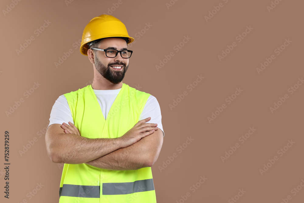 Engineer in hard hat on brown background