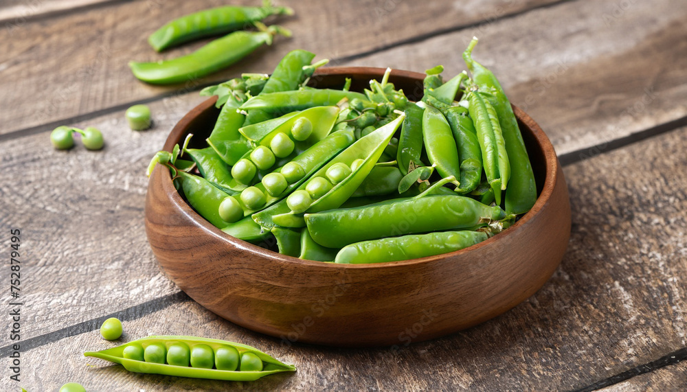 Cloce-up view of Hearthy fresh green peas and pods in wooden bowl on rustic background Cloce-up view of Hearthy fresh green peas and pods in wooden bowl on rustic background