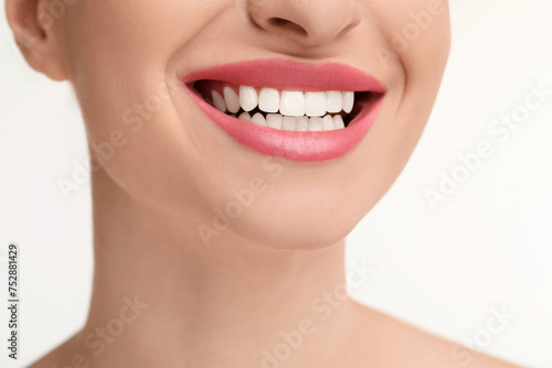 Young woman with beautiful smile on white background, closeup
