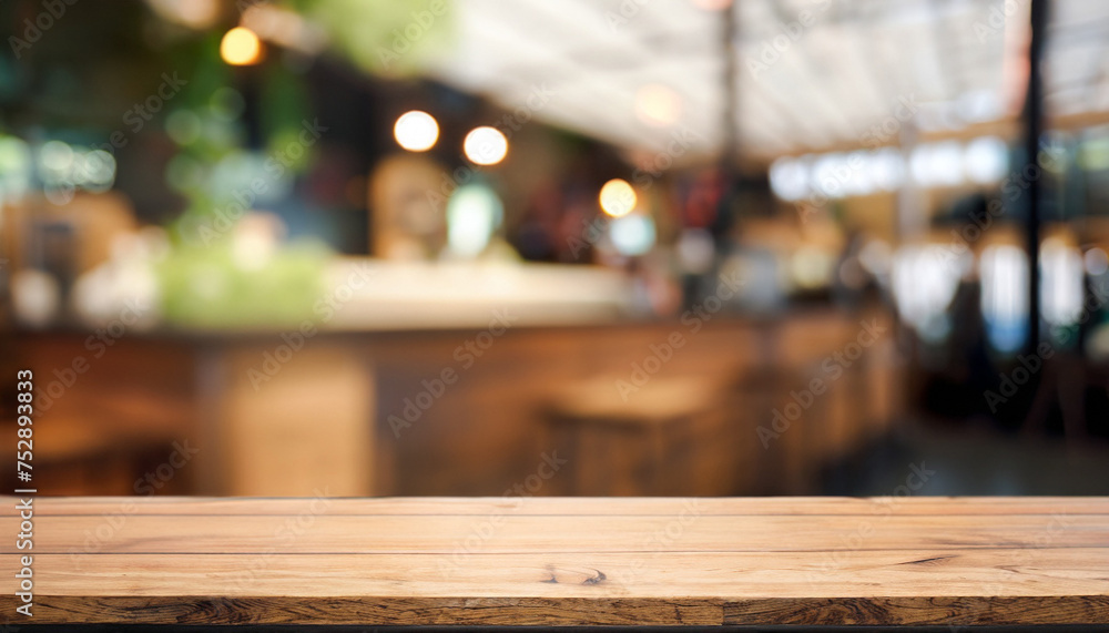 Wood table on blur of cafe, coffee shop, bar, background; empty wooden desktop mock up