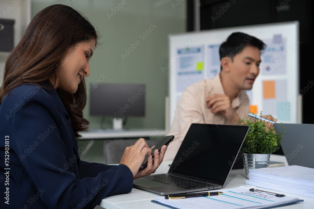 Asian businessman showing hand and smiling young team of colleagues making good business discussion in modern coworking office concept teamwork people. Asian businessman showing hand and smiling young team of colleagues making good business discussion in modern coworking office concept teamwork people.