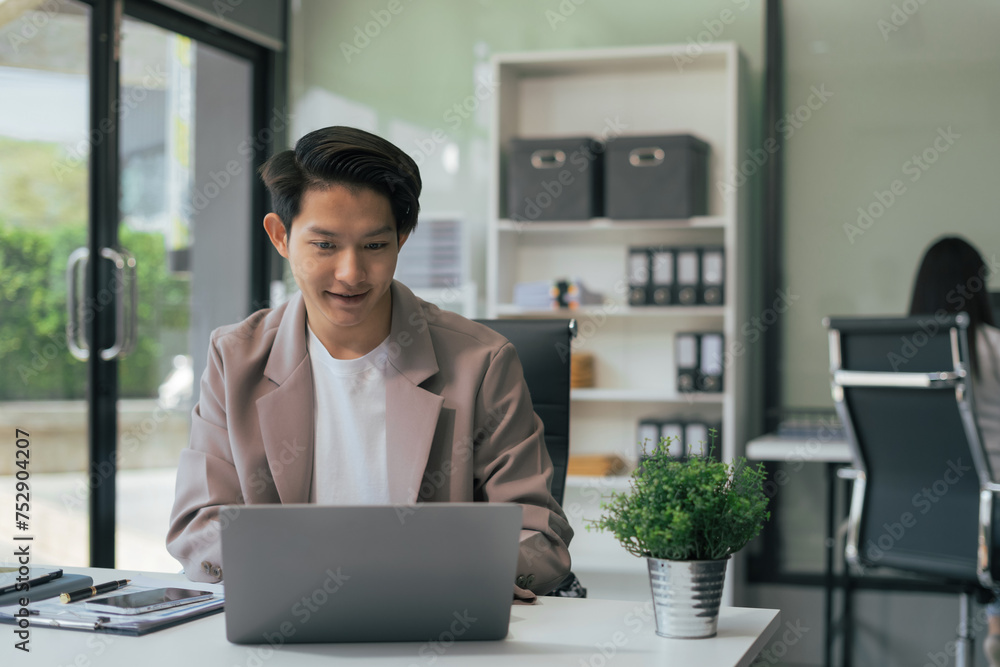 Businessman using a tablet and computer to analysis graph company financial with colleagues at office. Businessman using a tablet and computer to analysis graph company financial with colleagues at office.