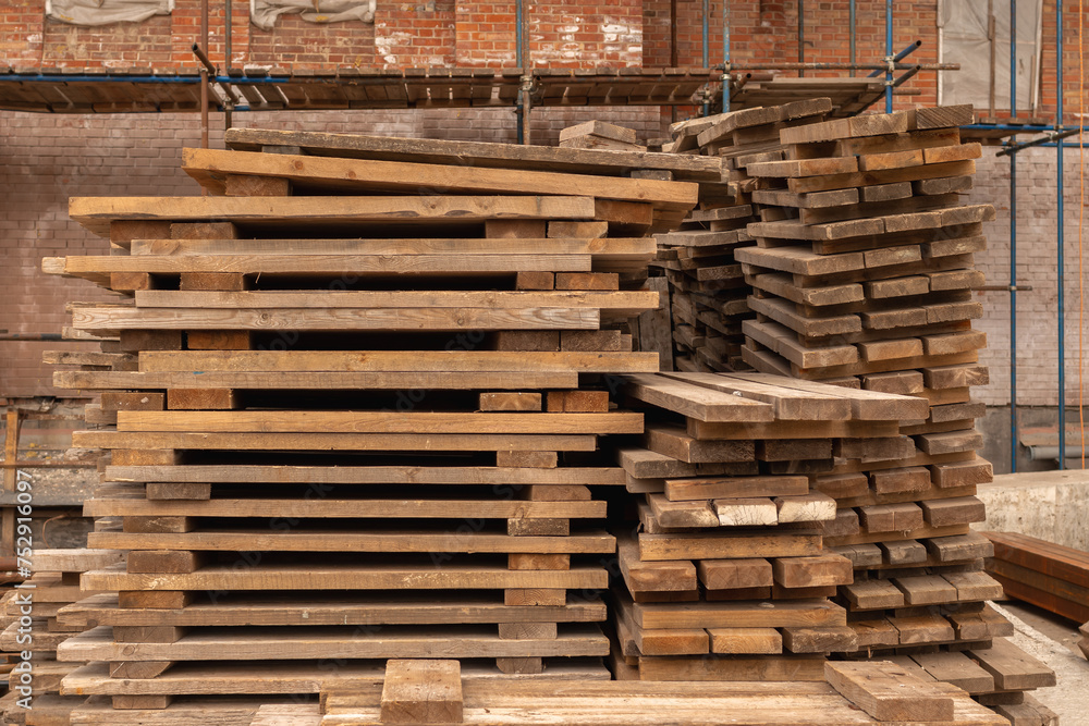 Shelves with wooden planks in front of the scaffolding of a temple under construction Shelves with wooden planks in front of the scaffolding of a temple under construction