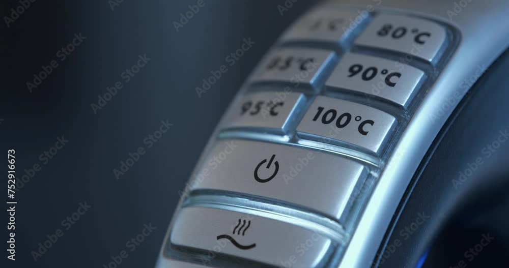 Kettle heated water to 100 degrees Celsius. Finger presses off button on a kettle. Turning off an electric kettle with adjustable water heating temperature Kettle heated water to 100 degrees Celsius. Finger presses off button on a kettle. Turning off an electric kettle with adjustable water heating temperature